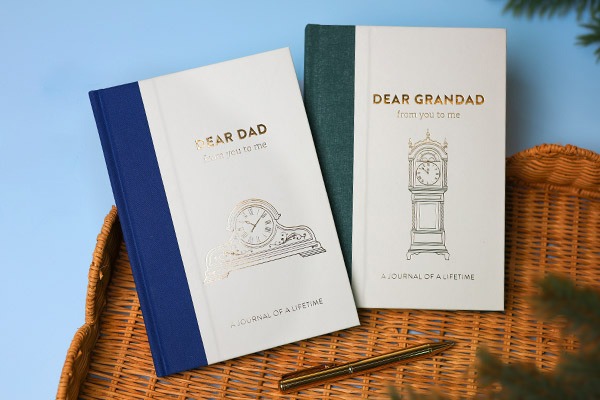 Dear Dad and Dear Grandad memory journals on wicker tray.