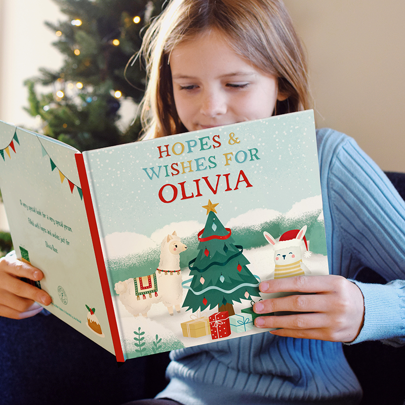 Young girl reading book with her name on it